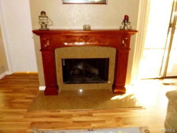 Rich wood laminate flooring, granite faced fireplace and rich wo
