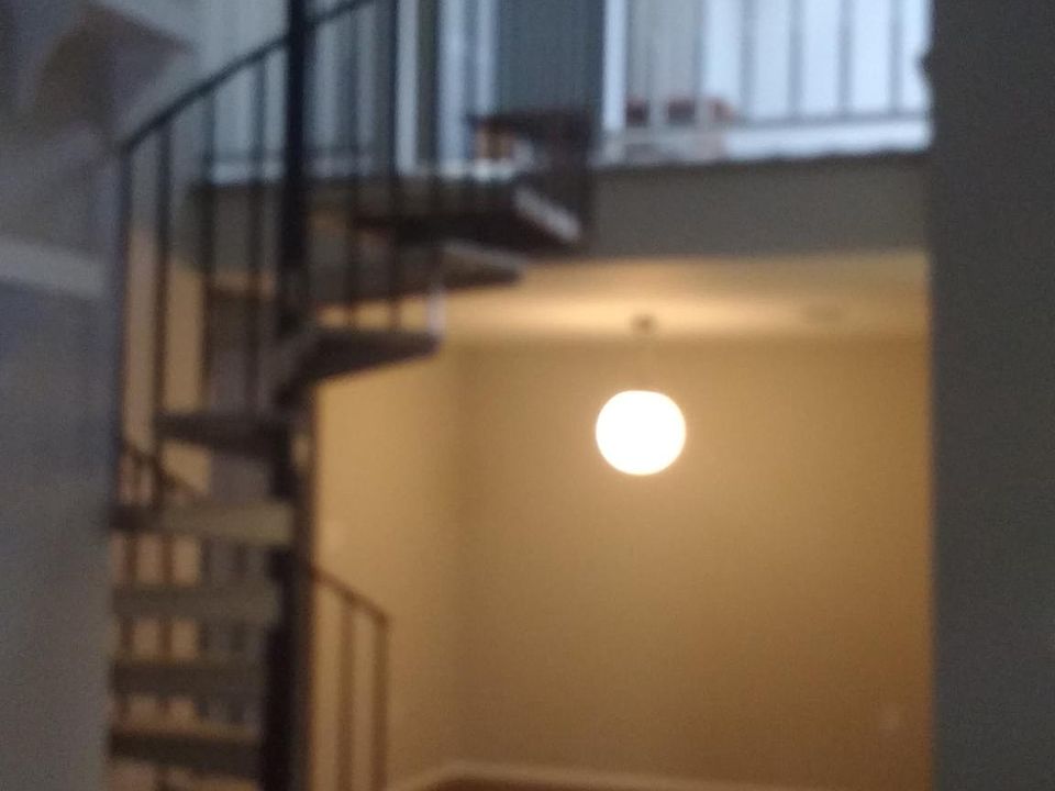 Spiral staircase leading to the loft. Dining room underneath