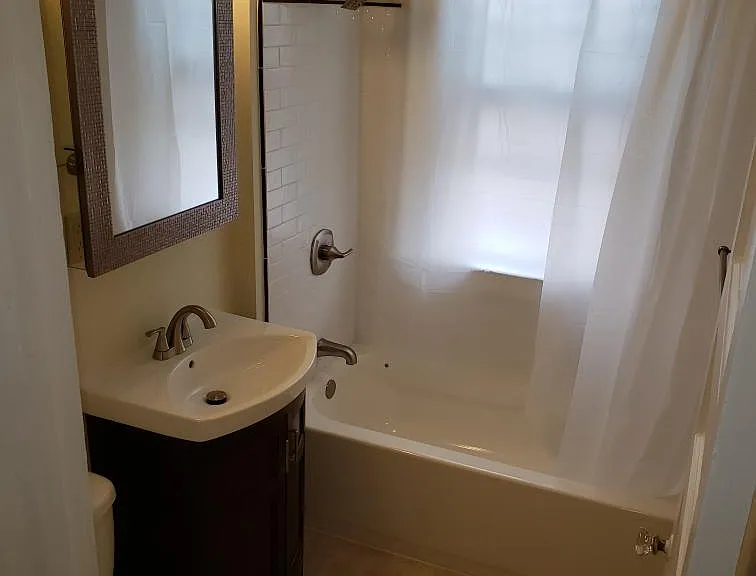 Bathroom 1 with tiled shower, nice medicine cabinet and lots of light