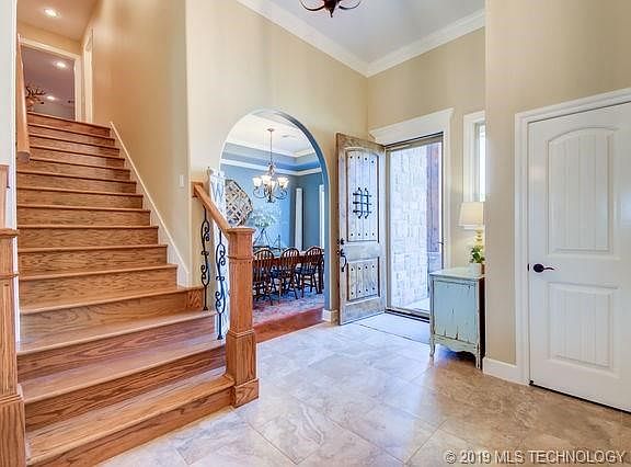 Large open entryway - wood staircase leads to bonus room with half bath!