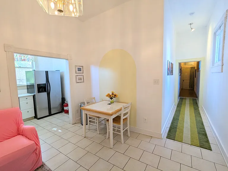 Living/dining with hall to bedrooms on right, note that for a rowhouse how much light there is!