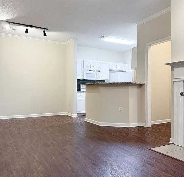 Dining area and kitchen from the living space. Small hallway to master bedroom on right.
