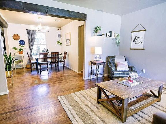Open floorplan with beamed headers, beautiful hardwood floors, a built-in bench seat in the dining room and a completely renovated kitchen of your dreams! Modern light fixtures and updates! Window treatments included!