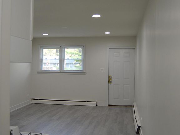Upper-Level Living Room w/ Front Door Access to Porch