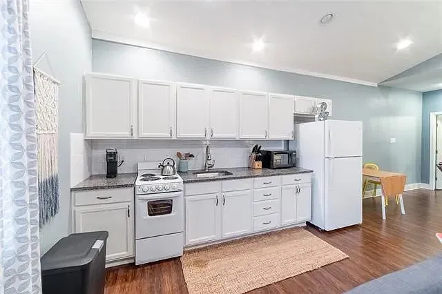 Modern kitchenette with stainless steel appliances and everything needed for convenient at-home cooking.