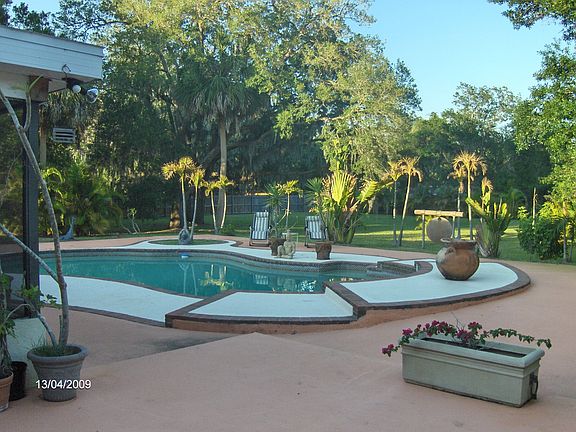 view from house to pool and yard