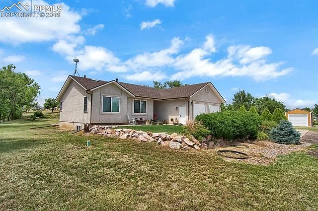 Low maintenance stucco exterior and septic system. Also, see detached 3rd car garage or workshop on right. New roof and gutters (JAN 2019) on house and detached garage.