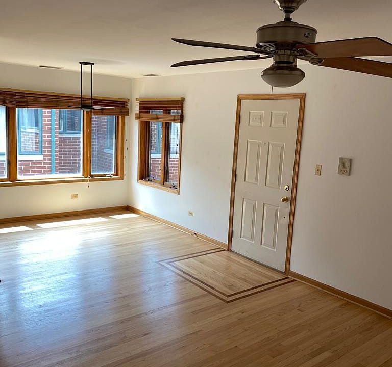 Living space indoor entrance. Hardwood floors in entire condo. Dining room lighting and living room ceiling fan and lighting.