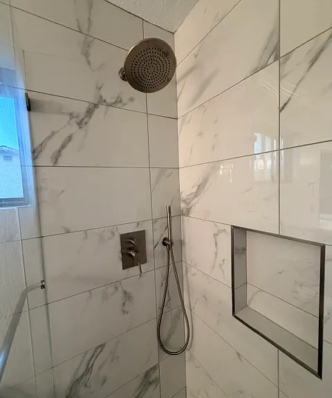 Brand new shower tile, fixtures, and glass. Never been used!