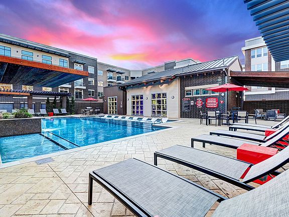 exterior pool and clubhouse with rolling overhead doors opening to the pool