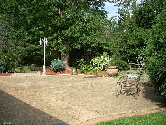 Nice brick patio in the lavishly landscaped and secluded back yard.