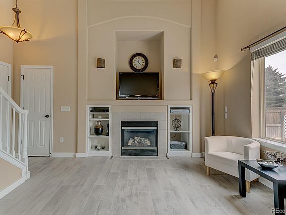 Dramatic living room features vaulted ceilings, updated lighting, gas fireplace, builtins, new flooring