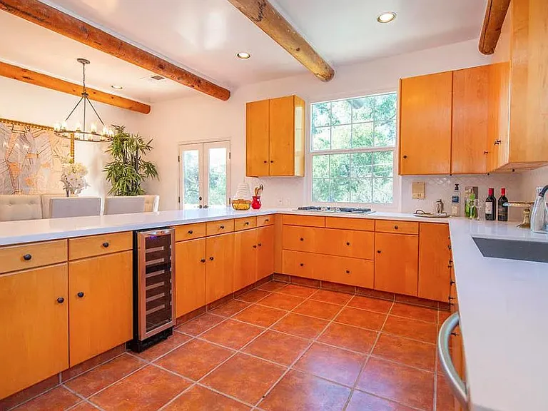 Wine fridge, downdraft venting on proffessional style cooktop, quartz counters, dishwasher, tons of storage