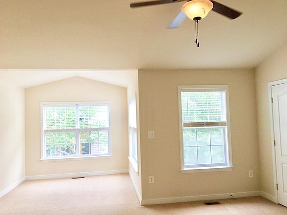 Primary bedroom with plenty of light and bumped-out sitting room.
