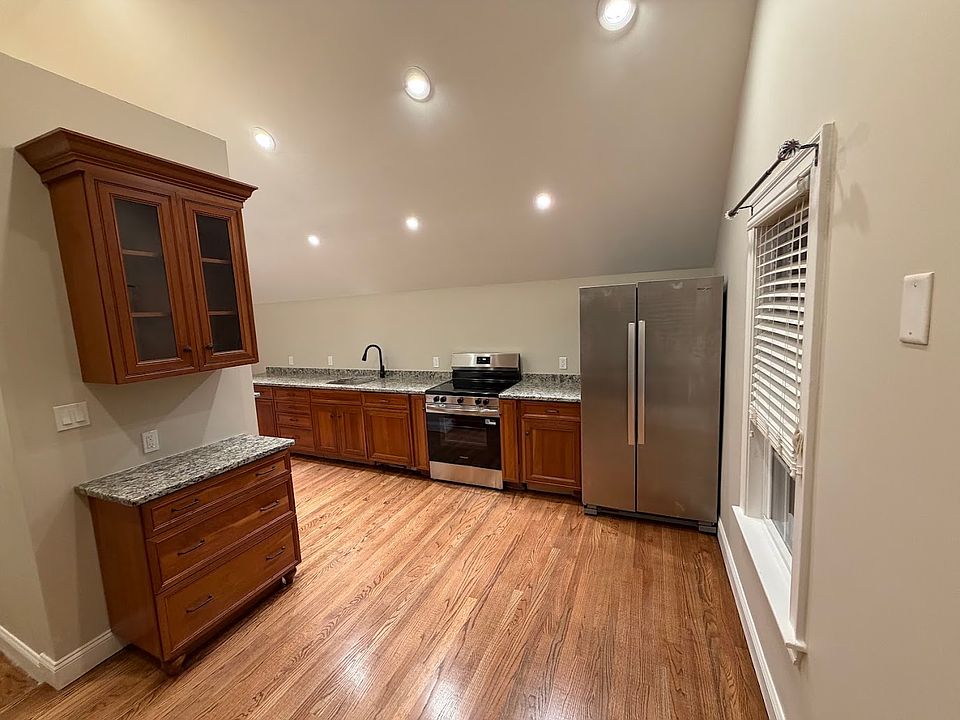 Open concept kitchen with stainless steel appliances.