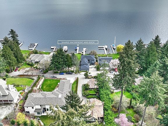 Steps and gravel path lead to the shared waterfront and dock.