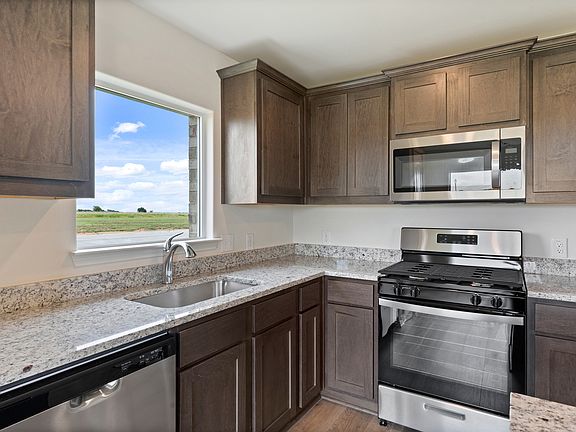 The kitchen has sprawling granite countertops.