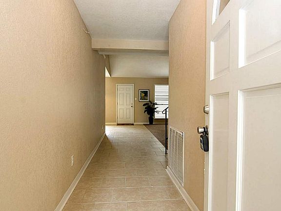 The solid front door opens to tile flooring and an entry hallway leading you to the spacious family room.