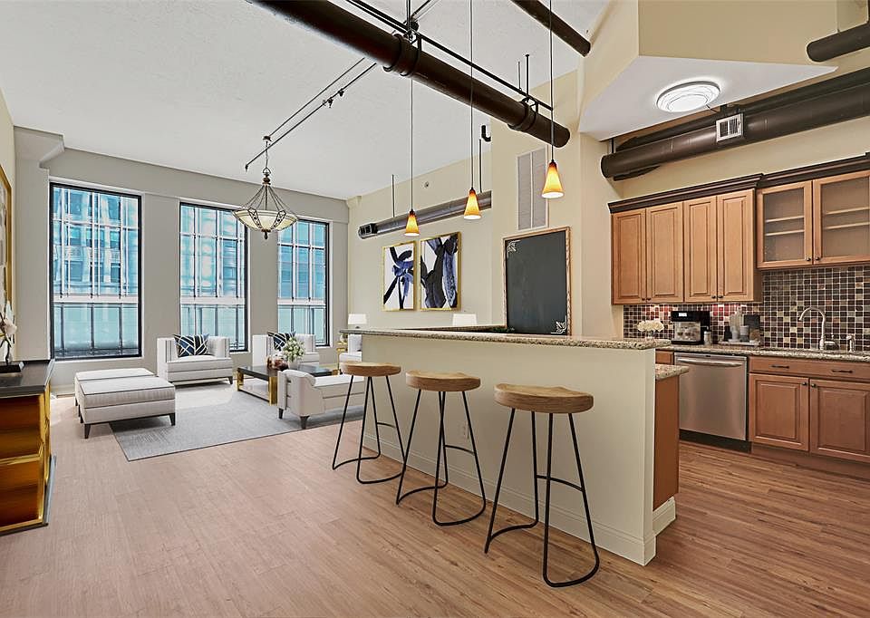Light, bright and airy with 16 ft ceilings, huge picture windows, wood floors replaced in 2020 and updated kitchen. Virtually Staged.