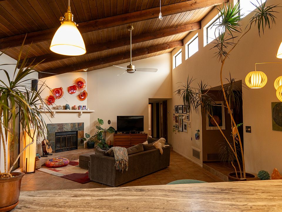 View from the open kitchen to the living room with cathedral ceilings.