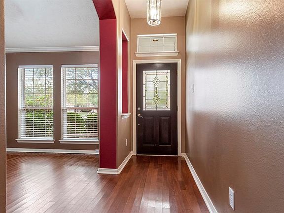 As you enter the foyer, you can see the high ceilings throughout and walls adorned with warm designer paint colors.