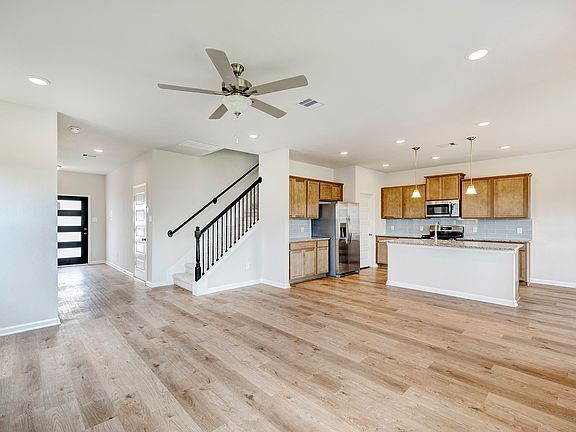 The Oriole II- Family Room into the Kitchen and Foyer.