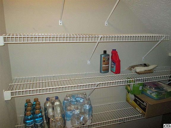 Huge walk-in pantry with extra storage under the stairs.