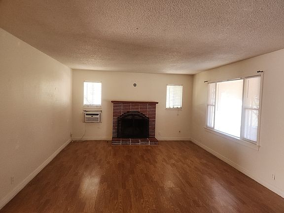 Living Room with Fireplace and window A/C unit.
