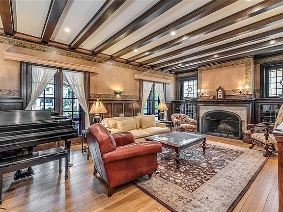Amazing Hand Painted Walls, Magnificent Log Burning Fireplace, Built-In Bookcases with Leaded Doors, Stained Glass and a Distinc