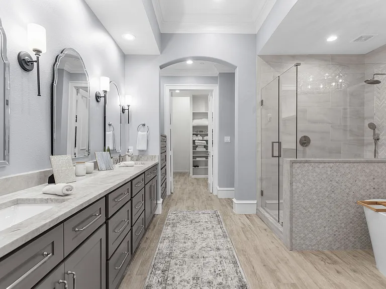 Ultimate relaxation awaits with a deep soaking tub and a modern glass shower.