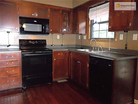 Kitchen area with Wood Laminate Flooring, Custom Cabinets and newer appliances.