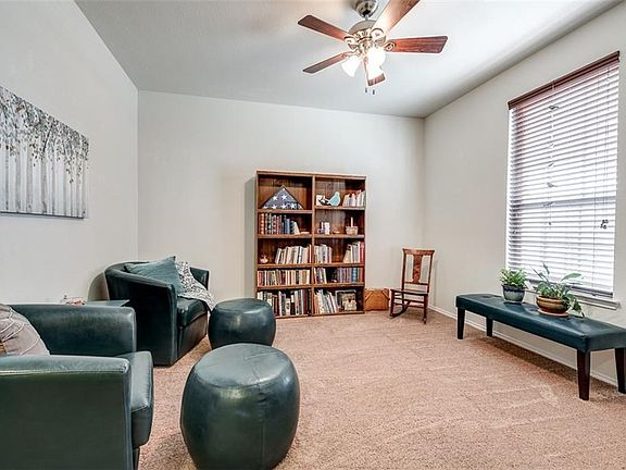 This second living area located at the front of the home would make a great study. Ceiling fan. 2 inch blinds. Berber Frieze carpet.