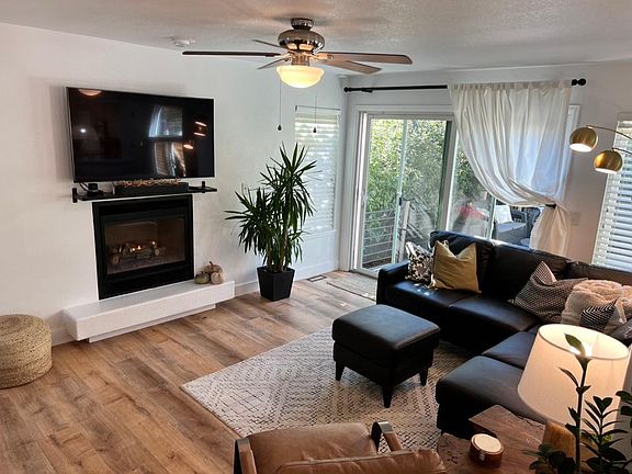 Living room with walk out to private patio with mature trees