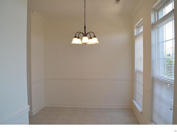 TILED DINNING AREA WITH CROWN MOLDING & CHAIR RAIL