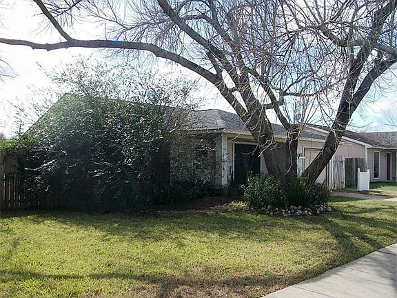 A side view of the home.  What a lovely large tree to shade the house.
