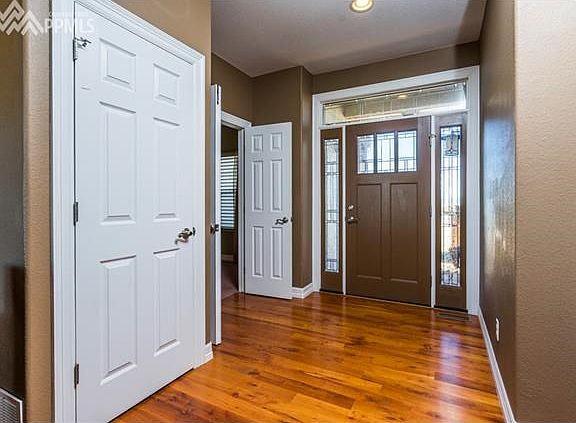 Be greeted by warm wood floors and intricate details as you enter this lovely home