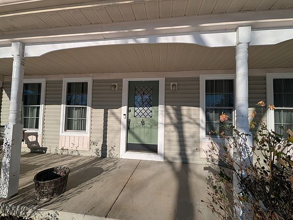 Covered front porch with swing and garage access