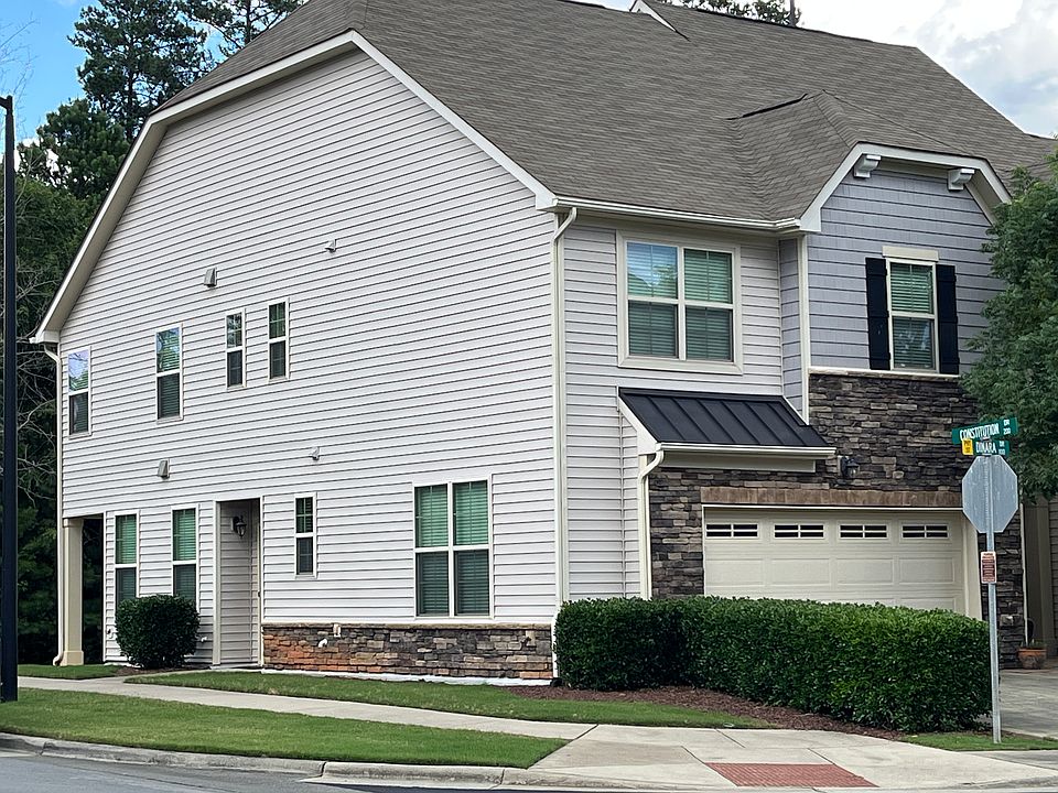 exterior, facing northeast. two-car garage to right, entry center, covered patio on left
