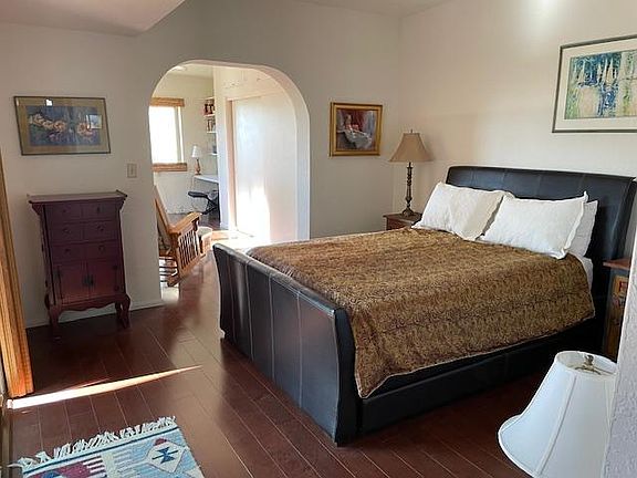 Master bedroom with ensuite bathroom, sliding door to patio, and private office (and ceiling fans!)