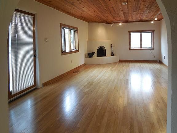 Living room shown without furniture. Entry door on the left