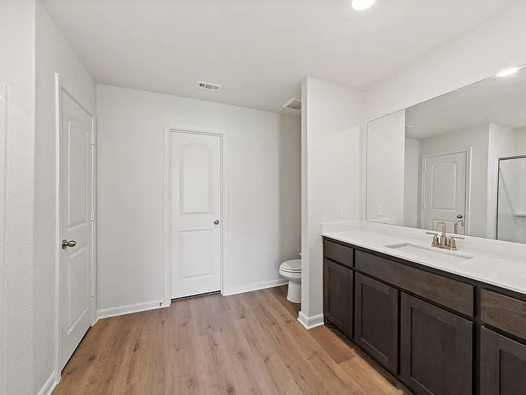 The master bathroom has a large vanity space.