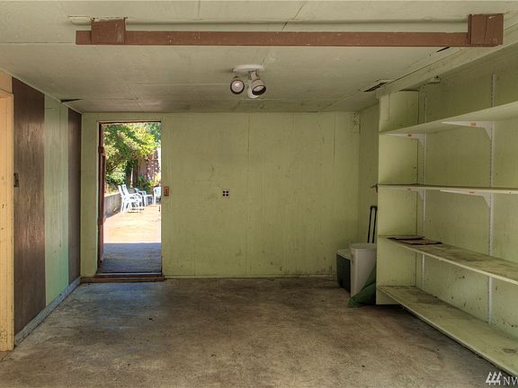 Single car garage and/or walk through to enter the back patio which takes you to the back home entry.  To the left is the shop.