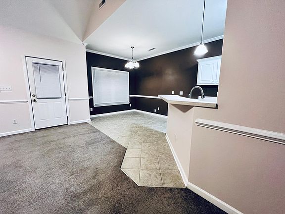Open floor plan features a formal dining room with easy access to the kitchen and living room.