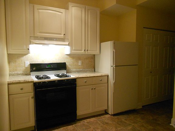 Stove and fridge in kitchen.