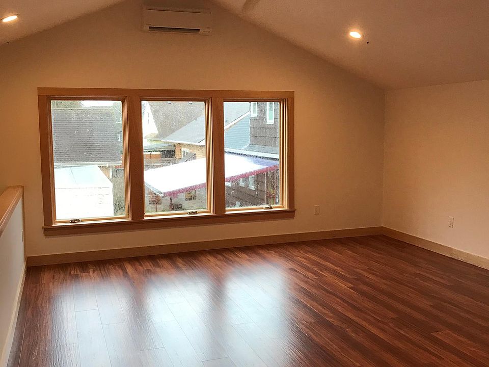 View of great room from kitchen. Southern facing; tons of light. Ceiling fan as well as heat/AC unit.
