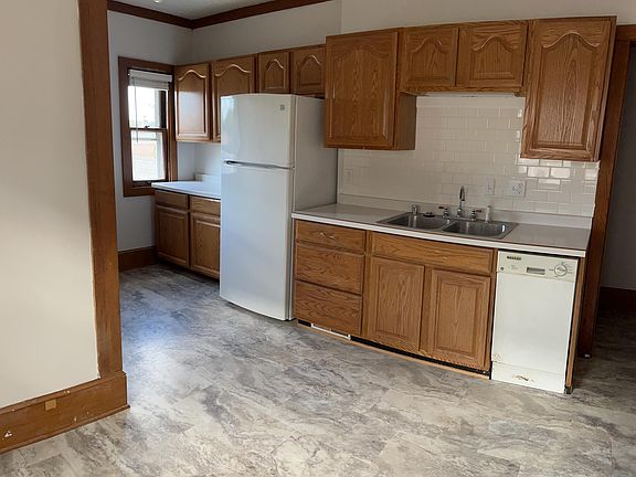 Expanded kitchen has refrigerator and room for small table.
