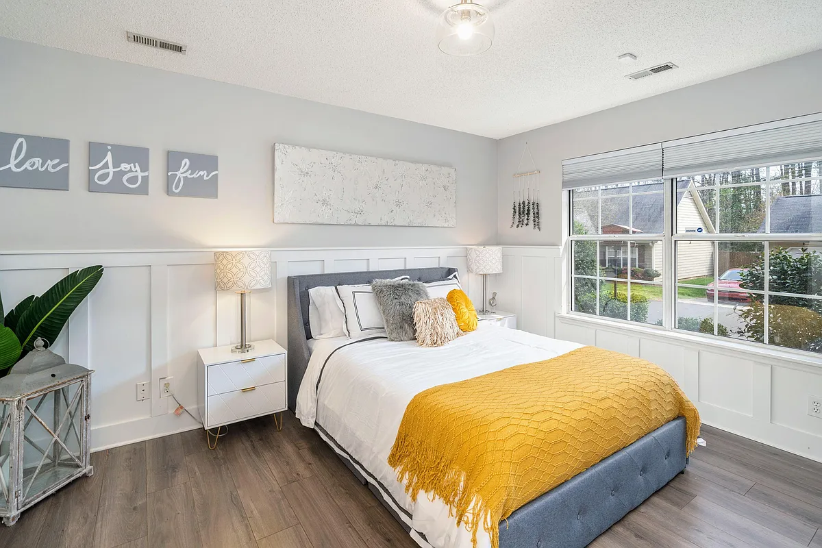 Open and spacious primary bedroom w/wood floors and wainscot trim - High Ridge Dr