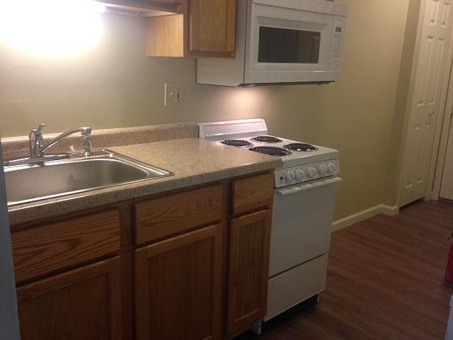 Kitchen with stove, microwave, and refrigerator