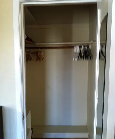 This is a large closet with a door to the living room