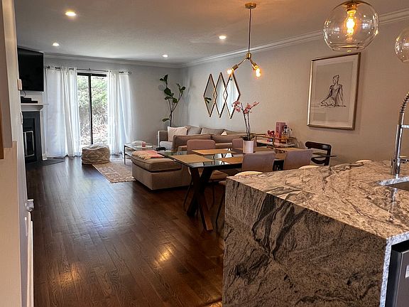 Waterfall edge countertop with bar stools for easy entertaining. Open concept.